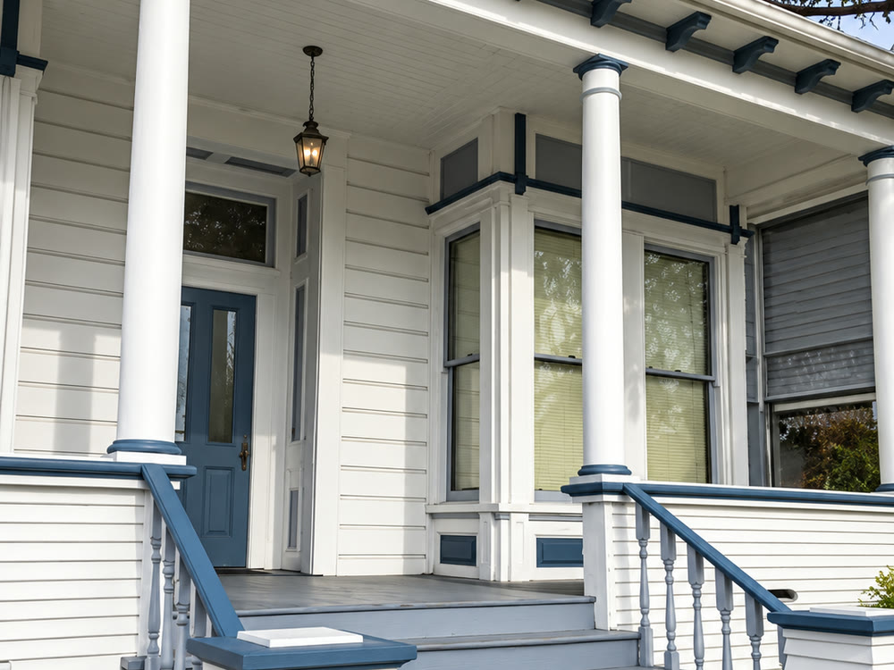 The white Victorian building at 1023 4th Street, with its columned porch and blue-painted steps